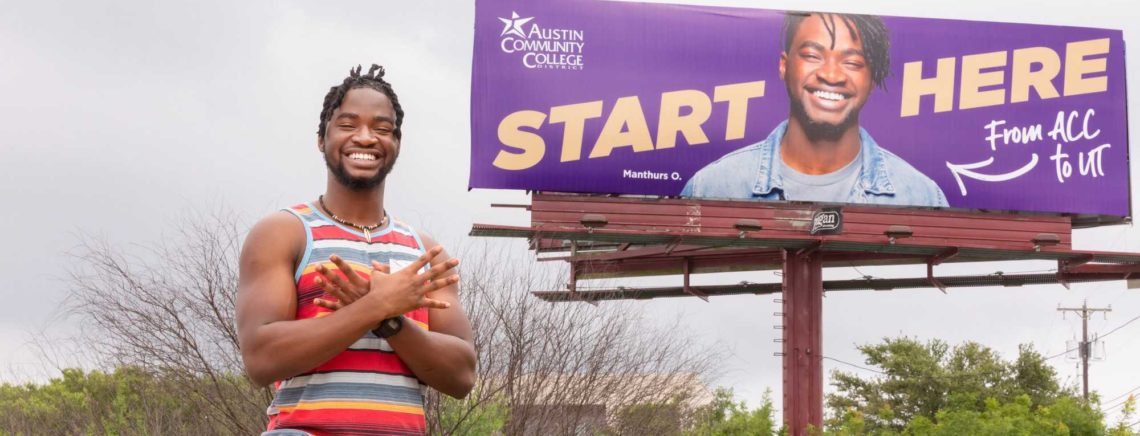 ACC alumnus poses for a portrait by a billboard for the ACC Fall 2021 registration campaign featuring an image of him on Monday, June 7, 2021, in Pflugerville, Texas.