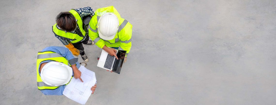 Civil engineer inspect structure at construction site against blueprint